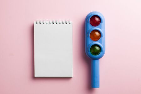 Toy traffic light, blank form on a colored background. Art concept of road traffic, accidents,...