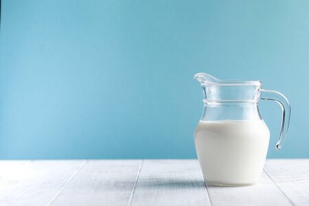  Glass cup with milk on a brown background with the inscription Milk Day. June 1st milk concept. Copy space. Horizontal food photo.の写真素材