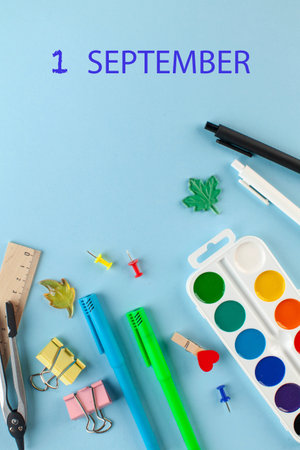 School stationery on a blue background. Inscription September 1st. Knowledge day concept. High quality photoの写真素材