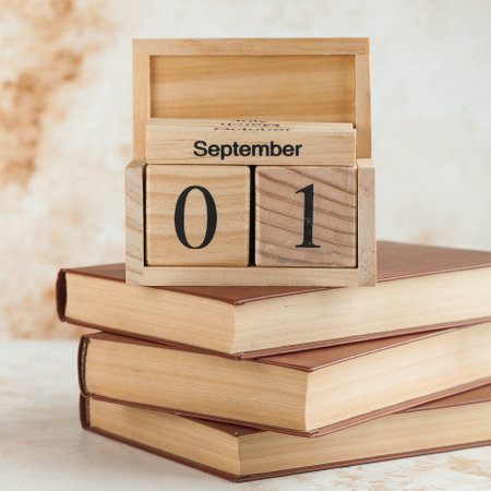 Wooden calendar September 1 on a stack of books. Concept for Knowledge Day, beginning of school...