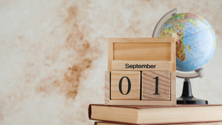 Wooden calendar September 1 on a stack of books, globe. Concept for Knowledge Day, beginning of...