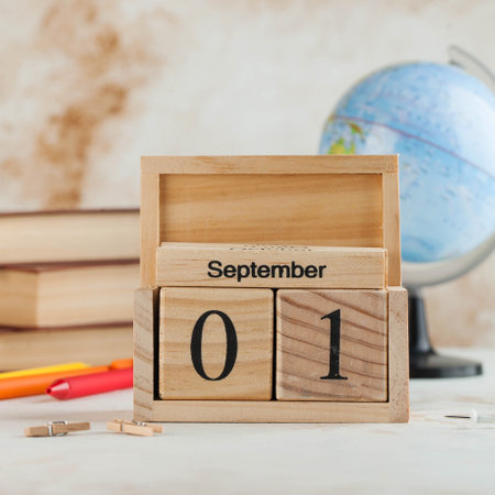 Wooden calendar September 1, books, globe. Concept for Knowledge Day, beginning of school year. Copy space. High quality photoの写真素材