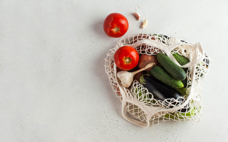 Fresh vegetables in a string bag, environmentally friendly product. Seasonal vegetables. Concept of harvesting, farming. High quality photoの写真素材