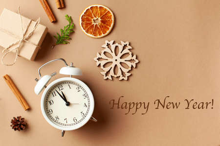 New years layout with alarm clock, gift, spices. The concept of new years eve. A gift with your own hands. Copy space.の写真素材