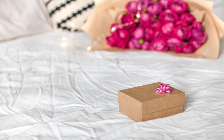 Gift boxe with pink ribbon on the bed. Concept of Valentine's day, March 8, birthday gift and other holidays. Copy space. High quality photoの写真素材