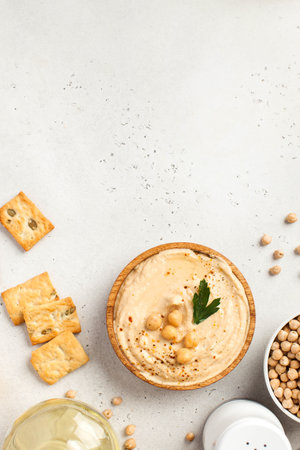 Flatlay hummus in a wooden plate, chickpeas, croutons. Dishes of chickpeas, a vegetarian dish. Copy space. High quality photoの写真素材