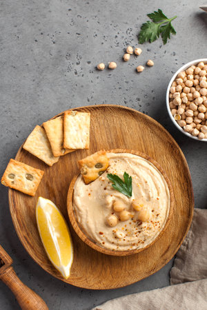 Flatlay hummus in a wooden plate, chickpeas, croutons. Dishes of chickpeas, a vegetarian dish. Copy space. High quality photoの写真素材