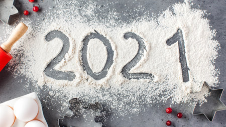 The number 2021 is drawn on flour. The concept of eve 2021, making Christmas cookies. High quality photoの写真素材