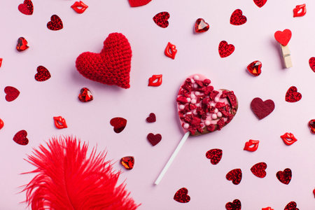 Flatlay Valentines Day greeting card. Different red hearts on a pink background. Concept of...
