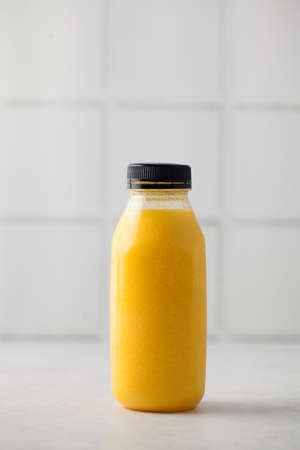 Yellow smoothie in a bottle. The concept of healthy eating. Layout. Copy space.の写真素材