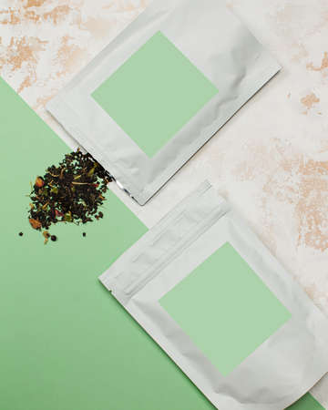 Aluminum bags with green tea with green label for textの写真素材