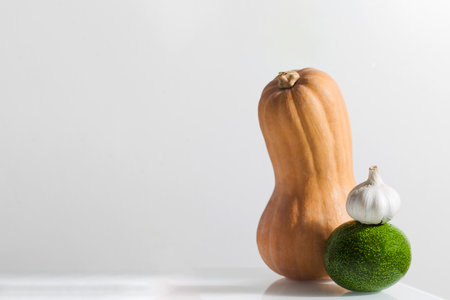 Fresh vegetables on a white background. Pumpkin, avocado, garlic. Copy space.の写真素材