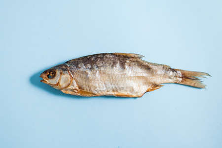 Dried salted fish on a wooden tray. A delicious snack for beer.の写真素材