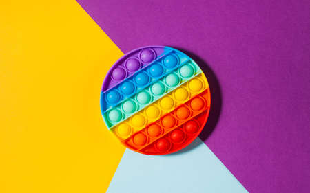 Pop it toy silicone on a colored background. Anti-stress toy, a trend in childrens toys. Copy space.の写真素材