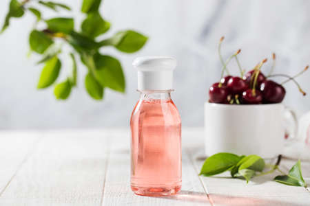 Liquid detergent cosmetic product with cherry berry extract. Organic shower gel, shampoo, liquid soap.の写真素材