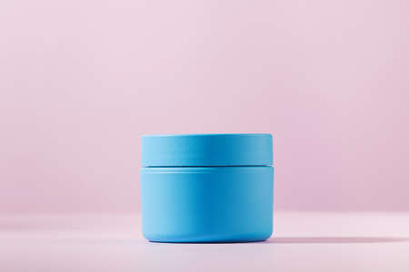 Mockup of a blue jar for cream, cosmetic mask on a pink background. Copy space.の写真素材