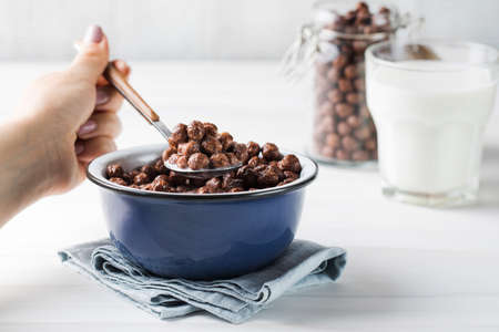 A dry breakfast of chocolate round flakes.