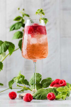 A refreshing cocktail with raspberries and ice cubes. Raspberry lemonade. Summer drinks.