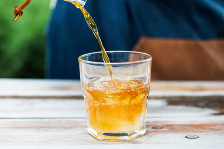 Cold coffee tonic. Coffee is poured into a glass with tonic and ice.の写真素材
