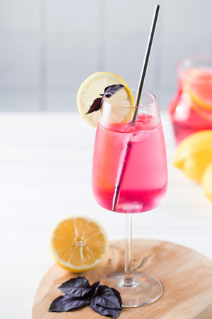 Refreshing summer drink in a glass, red basil lemonade.の写真素材