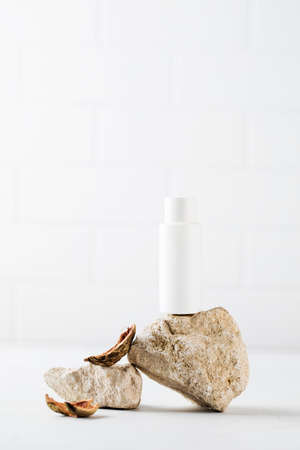 A white tube with an organic cosmetic care product surrounded by natural materials. The concept of eco cosmetics.の写真素材