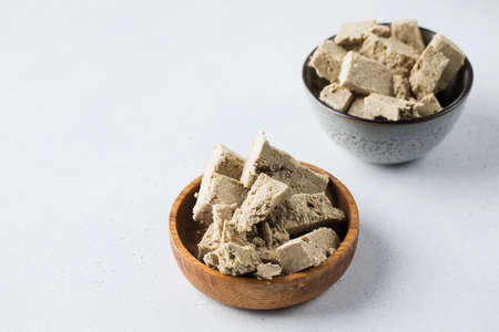 Halva slices in a bowls. Oriental sweetness. Copy space.