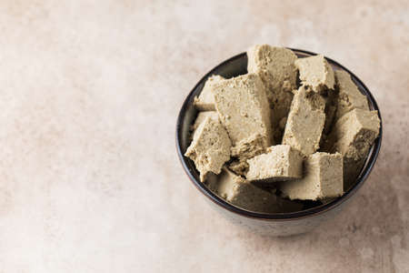 Halva slices in a bowl. Oriental sweetness. Copy space.