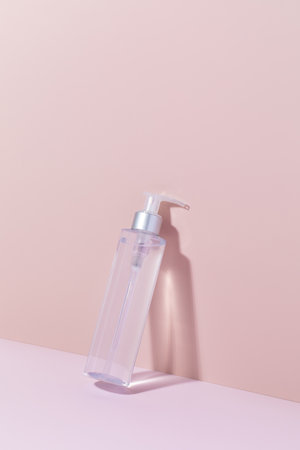 A mock-up of a cosmetic product on a pink background. Cleansing tonic for the face, micellar water. Copy space.の写真素材