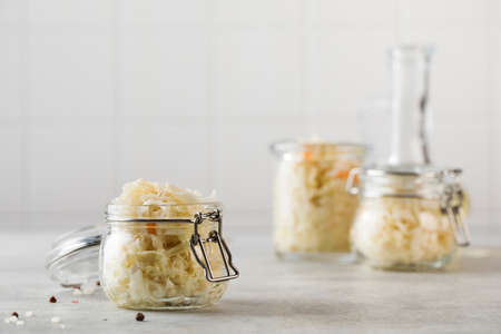 Sauerkraut in glass jars. Fermentation and canning of vegetables. Copy space.