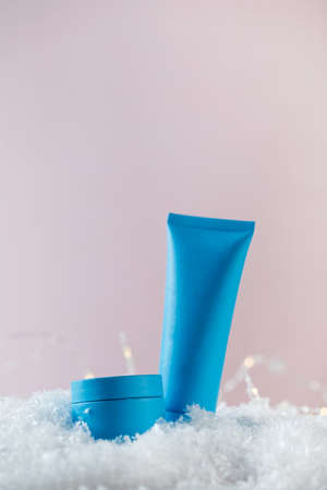 Blank jar and tube of winter cosmetic products in snowの写真素材