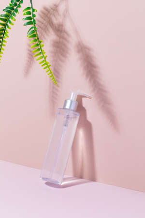 A mock-up of a cosmetic product on a pink background with shadows. Cleansing tonic for the face, micellar water.の写真素材