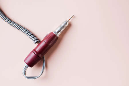 Fraser for hardware manicure and pedicure on a pink background. Specialized equipment for nail service masters.の写真素材