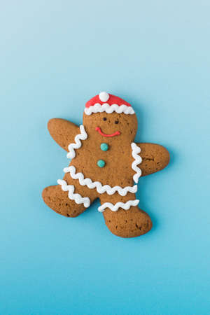 Gingerbread gingerbread man on a blue grand background. Christmas concept.