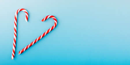 Banner christmas red and white lollipops on a gradient blue background. Christmas background. Copy space.の写真素材