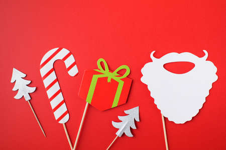 Group of cute paper Christmas party attributes on red template banner. Copy space.の写真素材