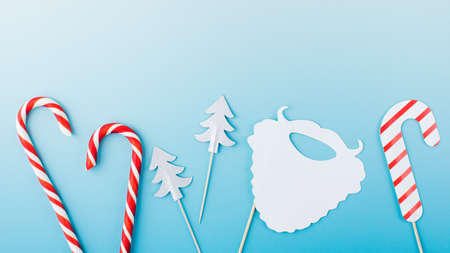 Group of cute paper Christmas party attributes on light blue template banner. Copy space.の写真素材