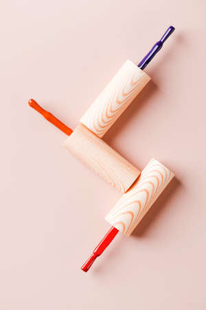 Different color brushes of bright nail polish bottles on light pink background. Copy space.の写真素材