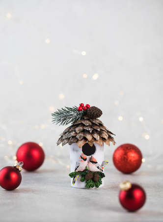 Christmas composition with red toy balls and a birdhouse. Copy space.の写真素材