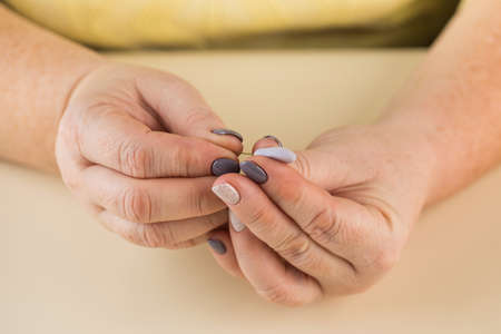 The master sculpts a petal from polymer clay to create a decorative flower.の写真素材