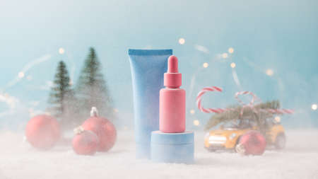 Mockup jars of cosmetic products on a Christmas background with falling snow. Gift for the new year.の写真素材