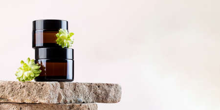 Mock up jars with natural cosmetic products on concrete plates on pinkの写真素材
