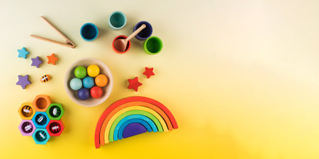 Eco-friendly colored wooden educational toys according to the Montessori method on a yellow...