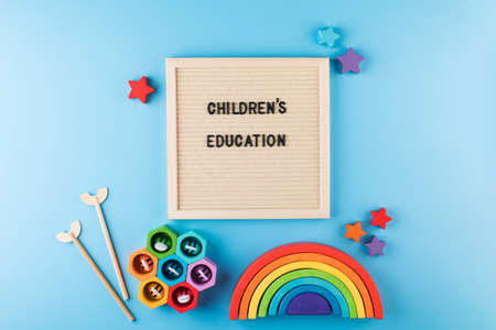 A frame with the words CHILDRENS EDUCATION surrounded by educational bright wooden toysの写真素材