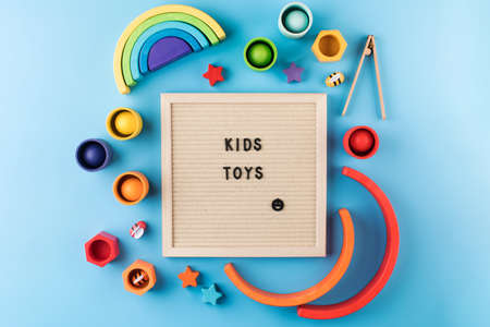Eco-friendly colored wooden educational toys for preschool children, a table with text KIDS TOYSの写真素材