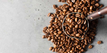 Turk with roasted coffee beans and grains around on a gray background. Copy space.の写真素材