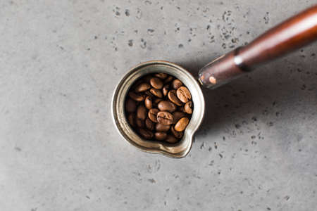 Turk with roasted coffee beans on a gray background. Copy space.の写真素材
