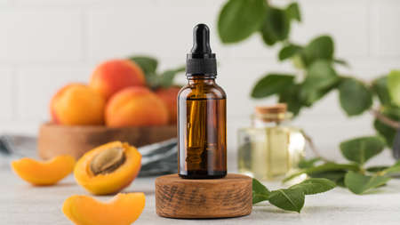 Mock up brown glass dropper with apricot seed oil. Natural cosmetic.