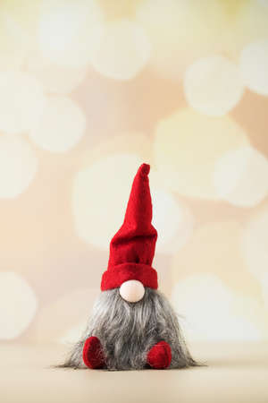 Christmas toy gnome on the background of Christmas lights and bokeh. New Yearの写真素材