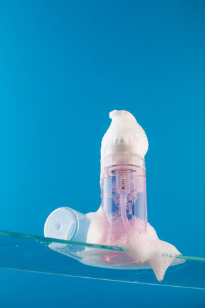 Dispenser mockup with face wash foam on a glass shelf. Acne remover, makeup remover. Skin care.