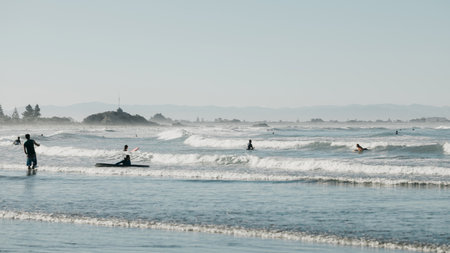 Sports water activities in the evening on the Pacific coast. The coast in New Zealand.